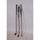 Three antique hickory shafted golf irons, 38½" long