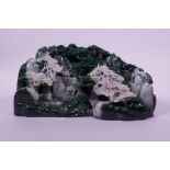 A moulded reconstituted jade ornament depicting a mountainous landscape with temples, 8½" x 4"