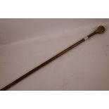 A bamboo walking cane with cast bronze skull handle and hallmarked silver band, 34" long