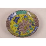 A Chinese porcelain shallow dish decorated in bright enamels with a butterfly and flowers on a