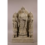 A Chinese blanc de chine figure group depicting Buddha flanked by other deities, impressed marks