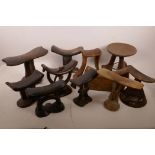 A box of African carved wood headrests and stools
