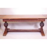 A Colonial, Anglo-Indian Padauk wood draw leaf refectory table, with carved frieze, raised on carved