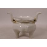 A Chinese cream glazed porcelain censer of hexagonal form raised on three supports, 5" high