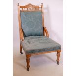 A Victorian walnut parlour chair with galleried back, raised on turned supports