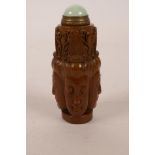 A Chinese amber soapstone snuff bottle with carved decoration of Quan Yin's face, mark to base, 3"