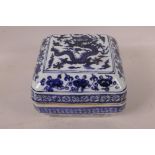 A Chinese square form blue and white porcelain box and cover decorated with a dragon and geometric
