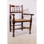 A child's rush seated spindle back elbow chair