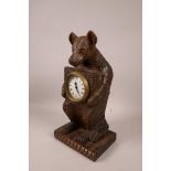 A Black Forest style carved wood bear mantel clock, 11½" high
