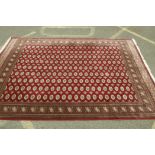 A large Bokhara pattern carpet, 118" x 77"