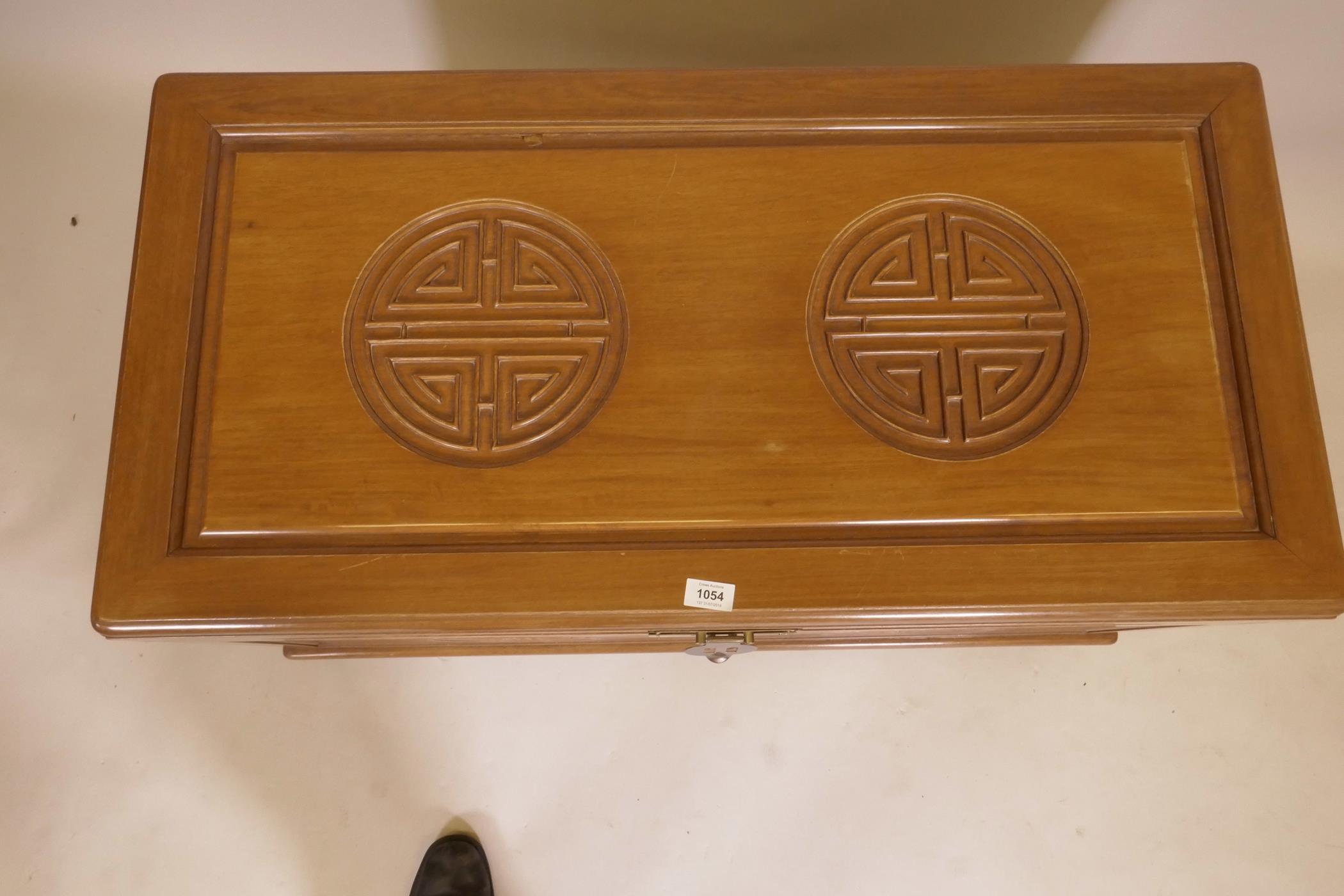 A Chinese camphorwood blanket chest with carved decoration, raised on shaped supports, late C20th, - Image 3 of 4