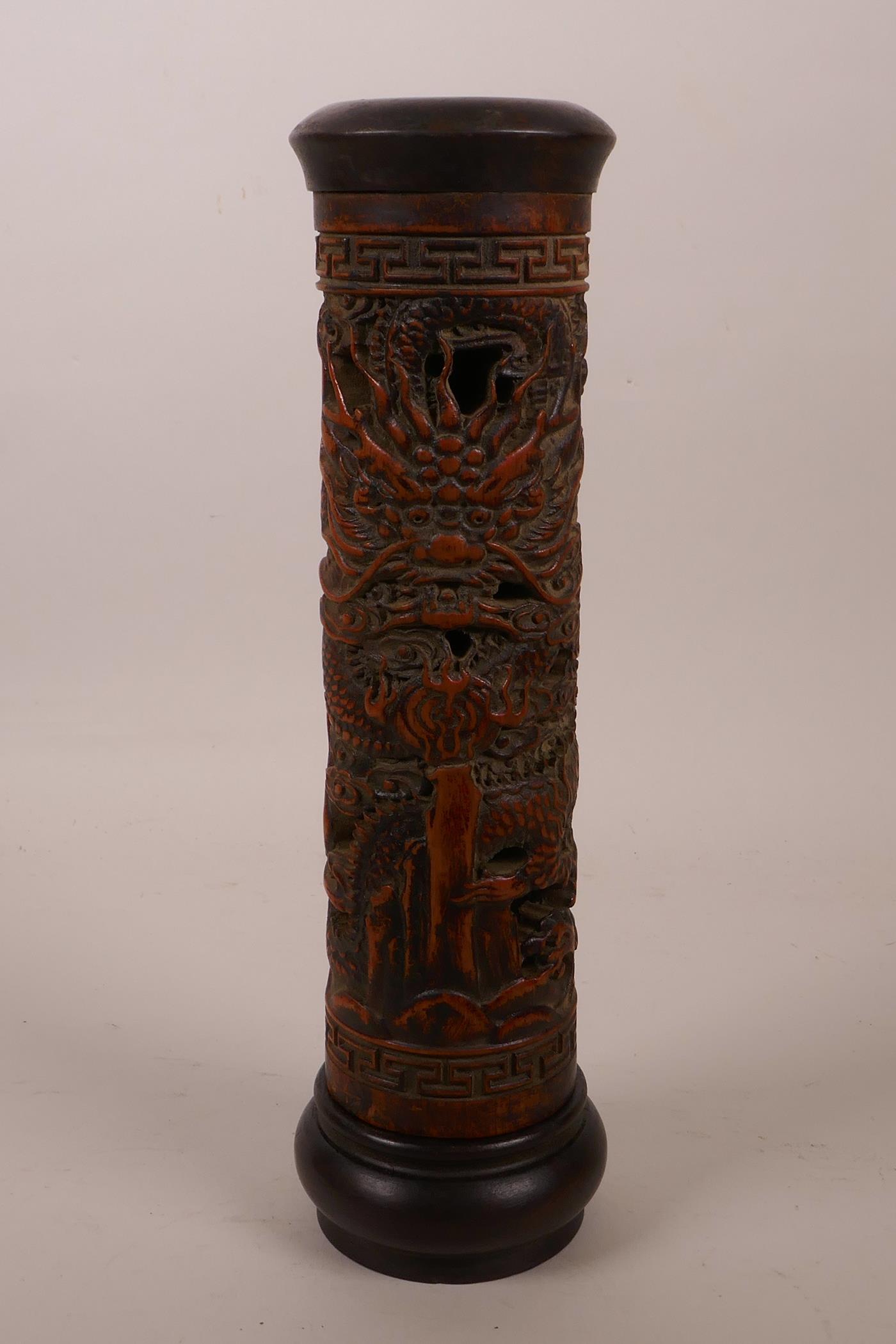 A Chinese bamboo and hardwood cylinder incense burner with carved and pierced dragon decoration, 10"