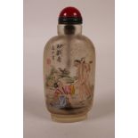 A Chinese reverse painted glass snuff bottle with erotic decoration, 4" high