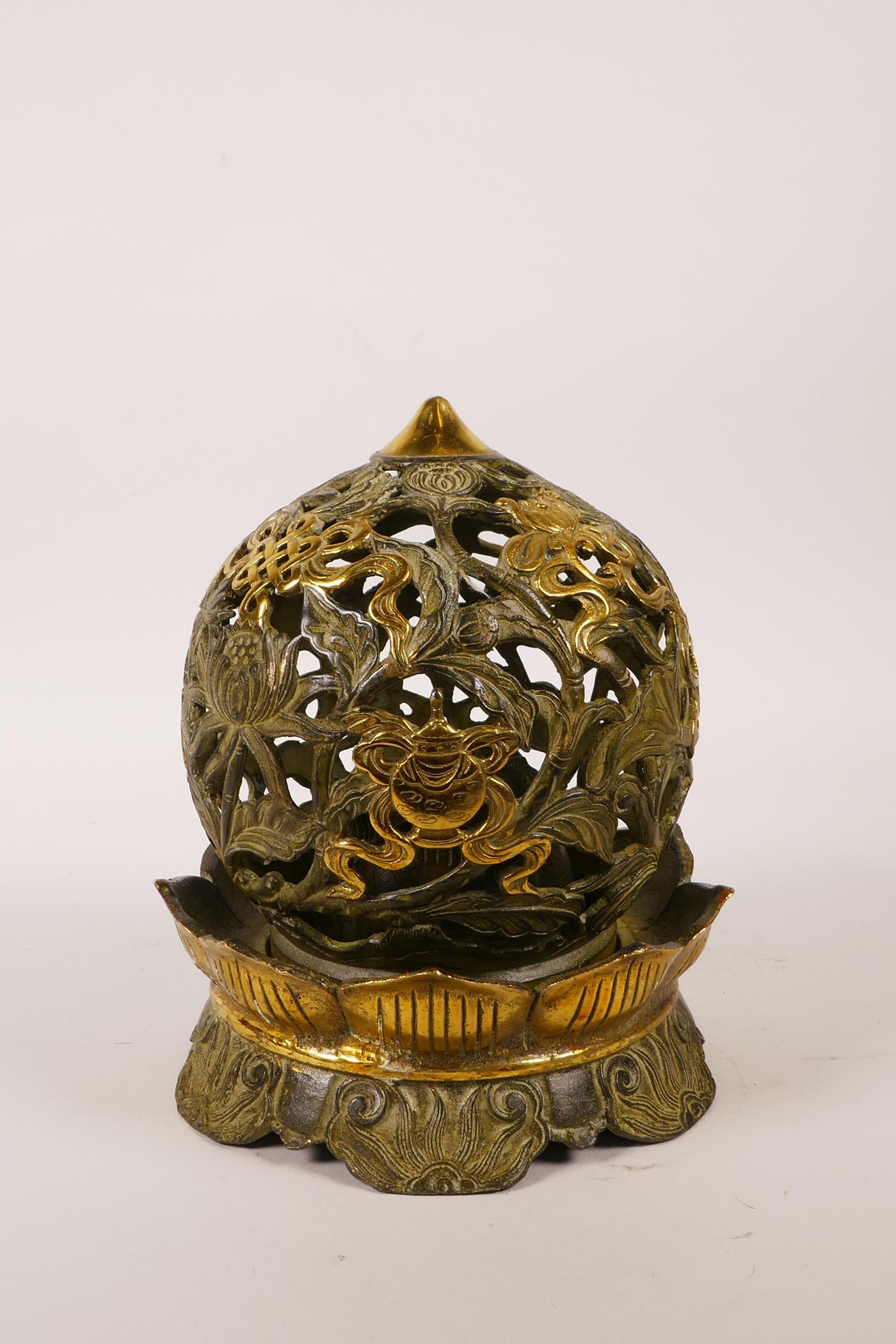 A Chinese pierced bronze ball censer decorated with the eight Buddhist treasures, highlighted with - Image 3 of 4