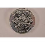 A silver plated vesta case with raised decoration of dogs, 1½" diameter