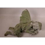 A cast metal garden figurine of a sleeping fairy, 16½" long