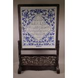 A Chinese blue and white porcelain table screen with calligraphy inscription, in a hardwood stand,