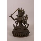 A Sino-Tibetan bronze of a seated deity on a lotus throne, impressed double vajra mark to base,
