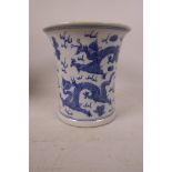 A Chinese blue and white porcelain brush pot with flared rim decorated with fiery dragons and