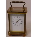 A heavy brass cased carriage clock with white enamel dial and black Roman numerals, marked Matthew