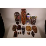 A quantity of African wood and pottery tribal masks, largest 20"