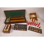 A mahogany box containing an inlaid cribbage board with bone markers and a vintage set of playing