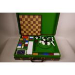 A Gucci style leather briefcase compendium of games, opening one side to reveal chess, draughts,