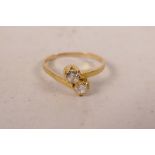 A yellow gold diamond set crossover ring, untested, approximate size 'J'