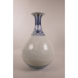 A Chinese blue and white porcelain pear shaped vase with a flared rim, and white decoration of