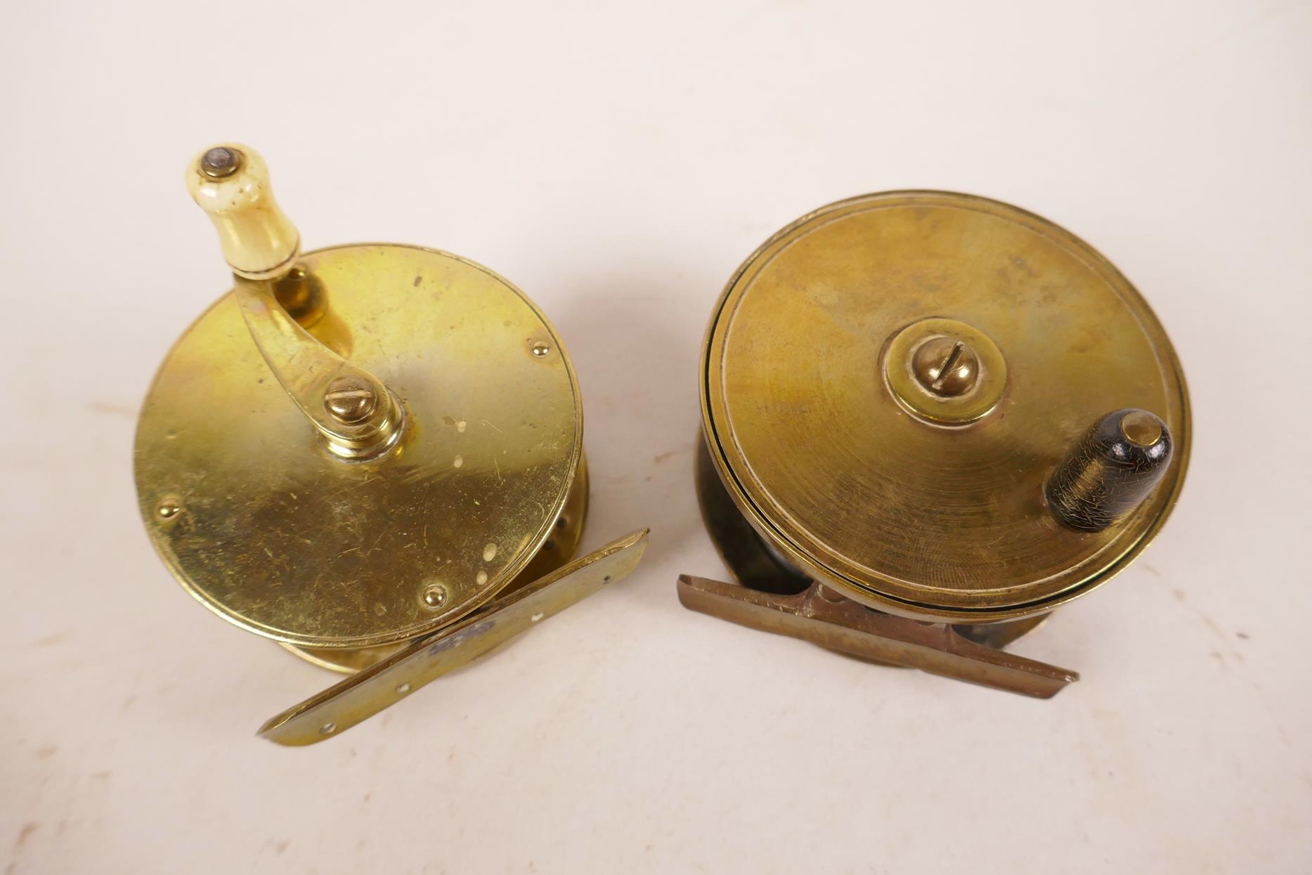 Two early brass trout fishing reels, 2¾" x 2¼" diameter