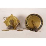 Two small brass and metal fishing reels, largest 2" diameter