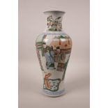 A Chinese famille verte porcelain vase decorated with figures watching a performance, 6 character