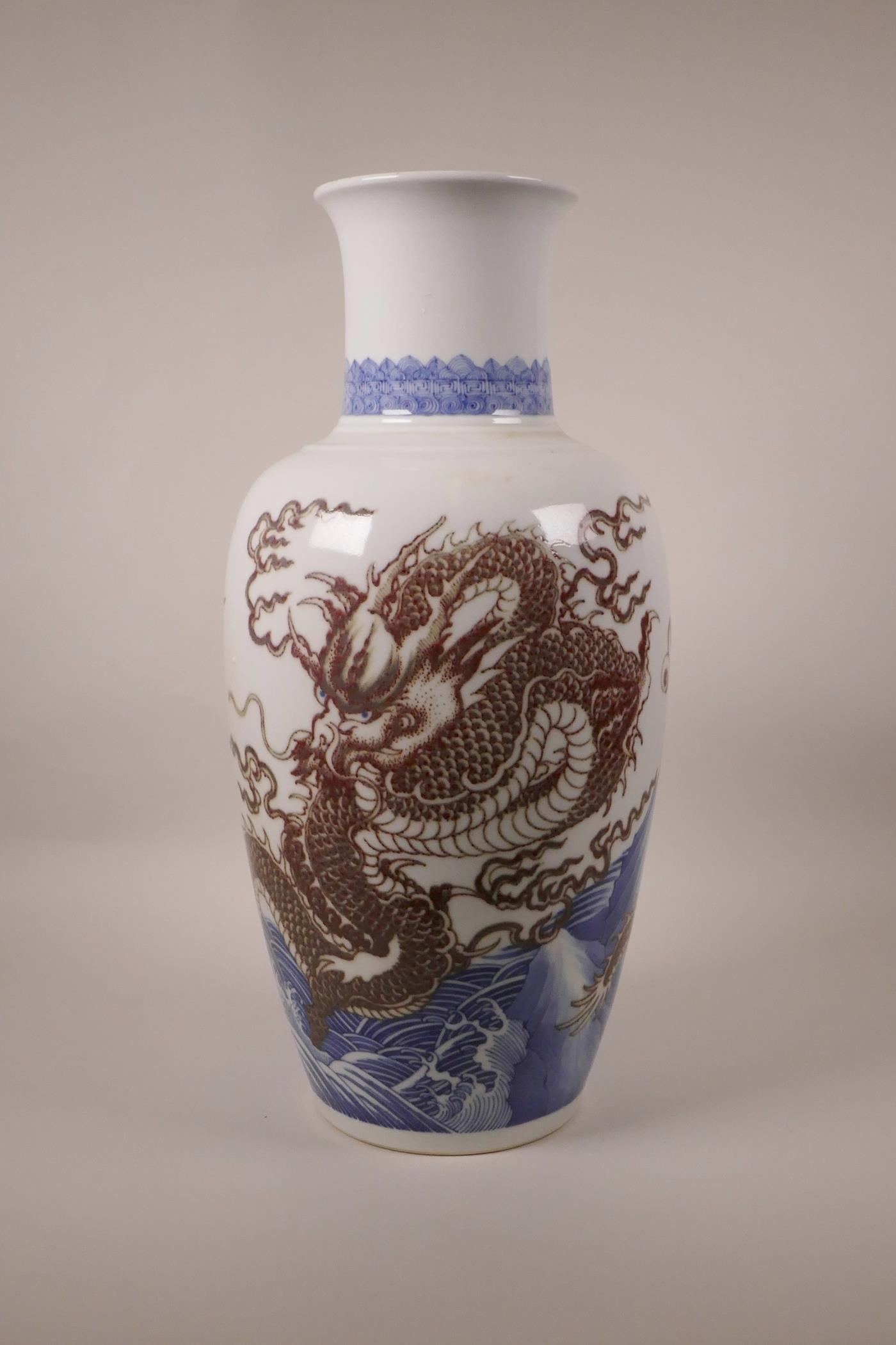 A large Chinese blue and white porcelain vase decorated with a red dragon chasing the flaming pearl,