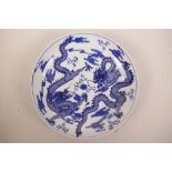 A Chinese blue and white porcelain cabinet plate decorated with two dragons chasing the flaming