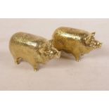 A pair of gold plated condiments in the form of pigs, 2½" long