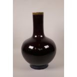 A Chinese pottery bottle vase with a flambé glaze, 4 character mark to base, 13½" high