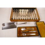 An oak canteen containing a set of twelve silver plated fish knives and forks, together with a Dixon