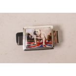 A chrome money clip with an applied silver mounted cold enamel plaque depicting a british bulldog,