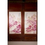 A pair of Chinese porcelain panels with pink enamelled decoration of riverside landscapes, mounted