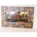 A painted wall mirror with raised decoration, 26" x 38"
