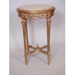 A Louis XV style giltwood occasional table with carved pierced frieze, fluted supports, pierced