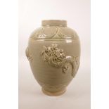 A Chinese celadon glazed pottery vase with raised decoration of a dragon and flaming pearl, 9½" high