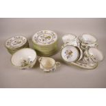 A Coalport Chinese flower pattern porcelain part tea set of 12 x 6½" plates, 11 x 5½" cups, milk