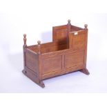 A C18th oak child's crib, with panelled sides and turned finials, 22" x 24" x 13"