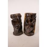 A pair of lignum vitae African bookends with carved figural decoration, 8" high