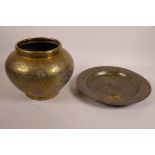 An Islamic brass vase with engraved script decoration, together with an Islamic brass dish on