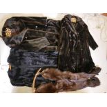 Two Astraka faux fur full length coats, together with another faux fur collarless coat and a twin
