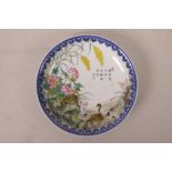 A Chinese polychrome porcelain cabinet plate decorated with waterfowl amongst the undergrowth,