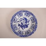 A Chinese blue and white porcelain charger with a lobed rim, decorated with birds and fruiting