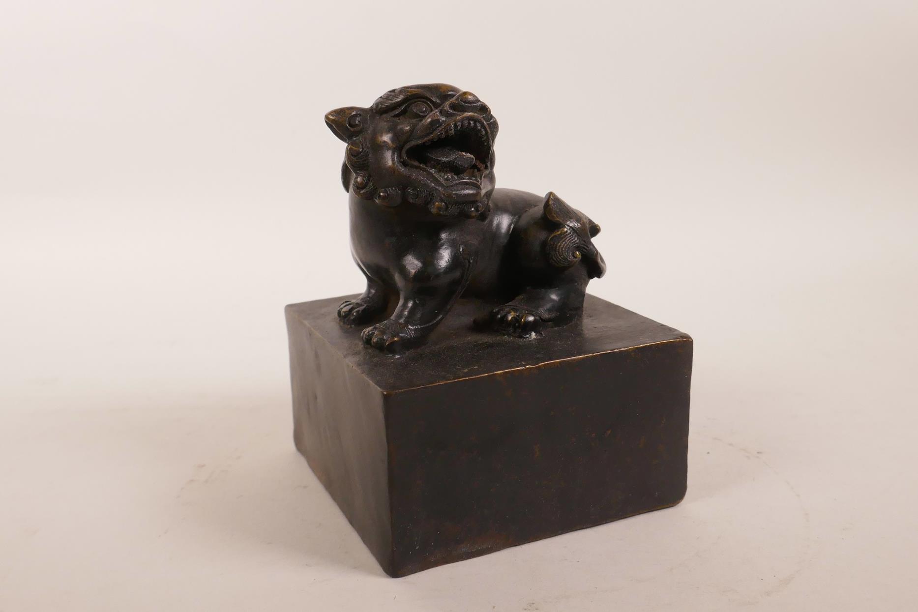 A Chinese square form filled bronze seal with a temple lion surmount, 4" x 4" x 5" - Image 2 of 4